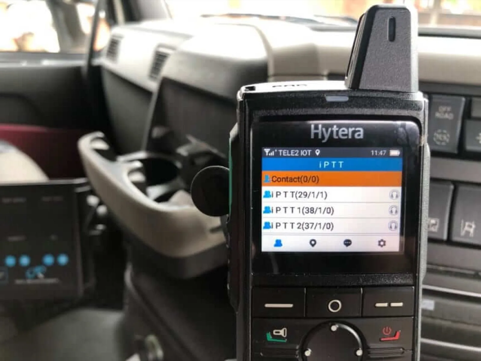 The iPTT walkie talkie app running on a Hytera PNC370 push-to-talk over cellular handset mounted in a vehicle cradle, showing the talkgroup list