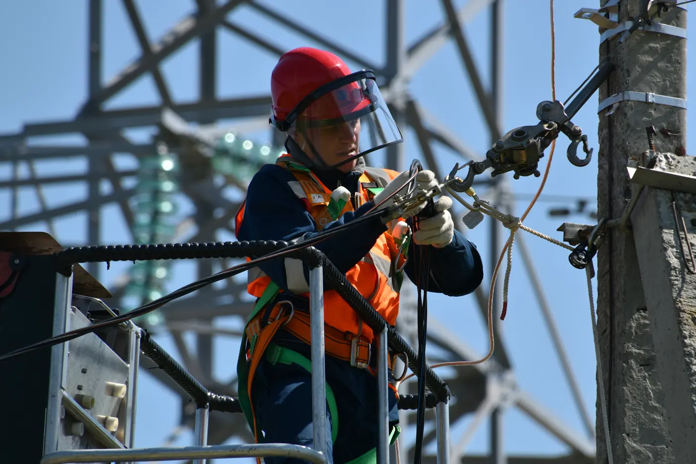 Electrician working alone on a construction lift utilising a radio in a windy situation