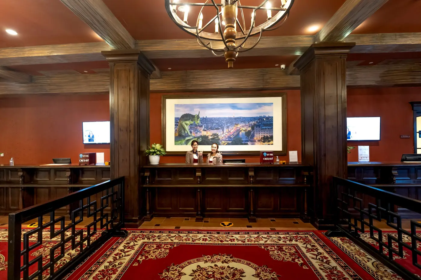 Hotel reception staff coordinating guest check-in using internal communication systems