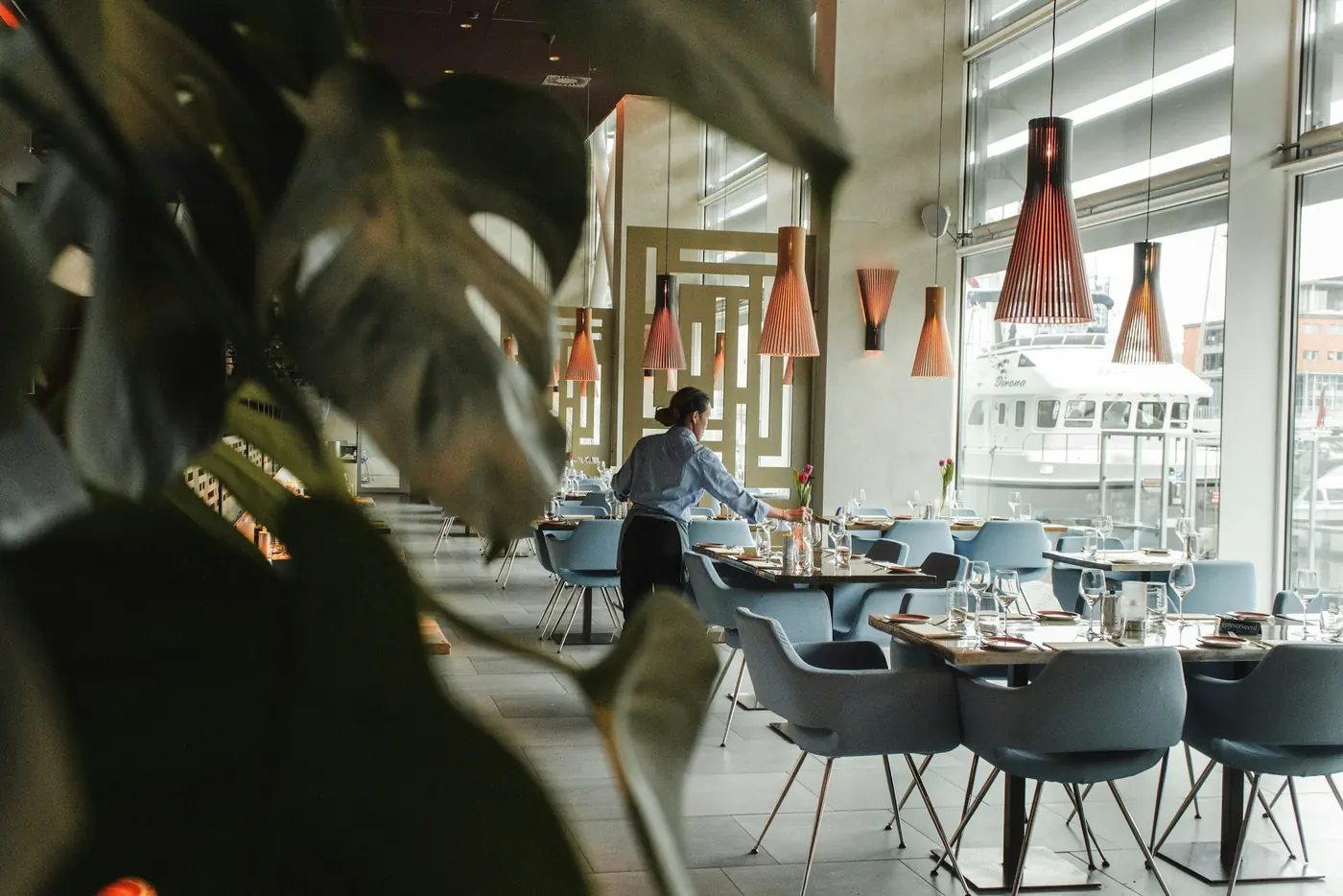 Hotel restaurant staff preparing tables and coordinating service in a hospitality environment
