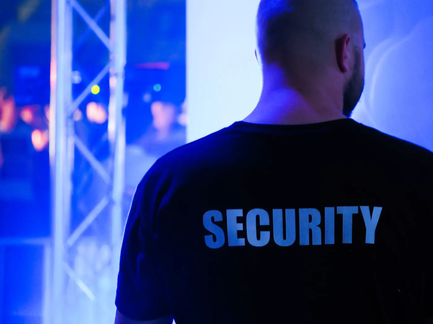Security guard supervising a nightclub whilst awaiting communications from supervisors