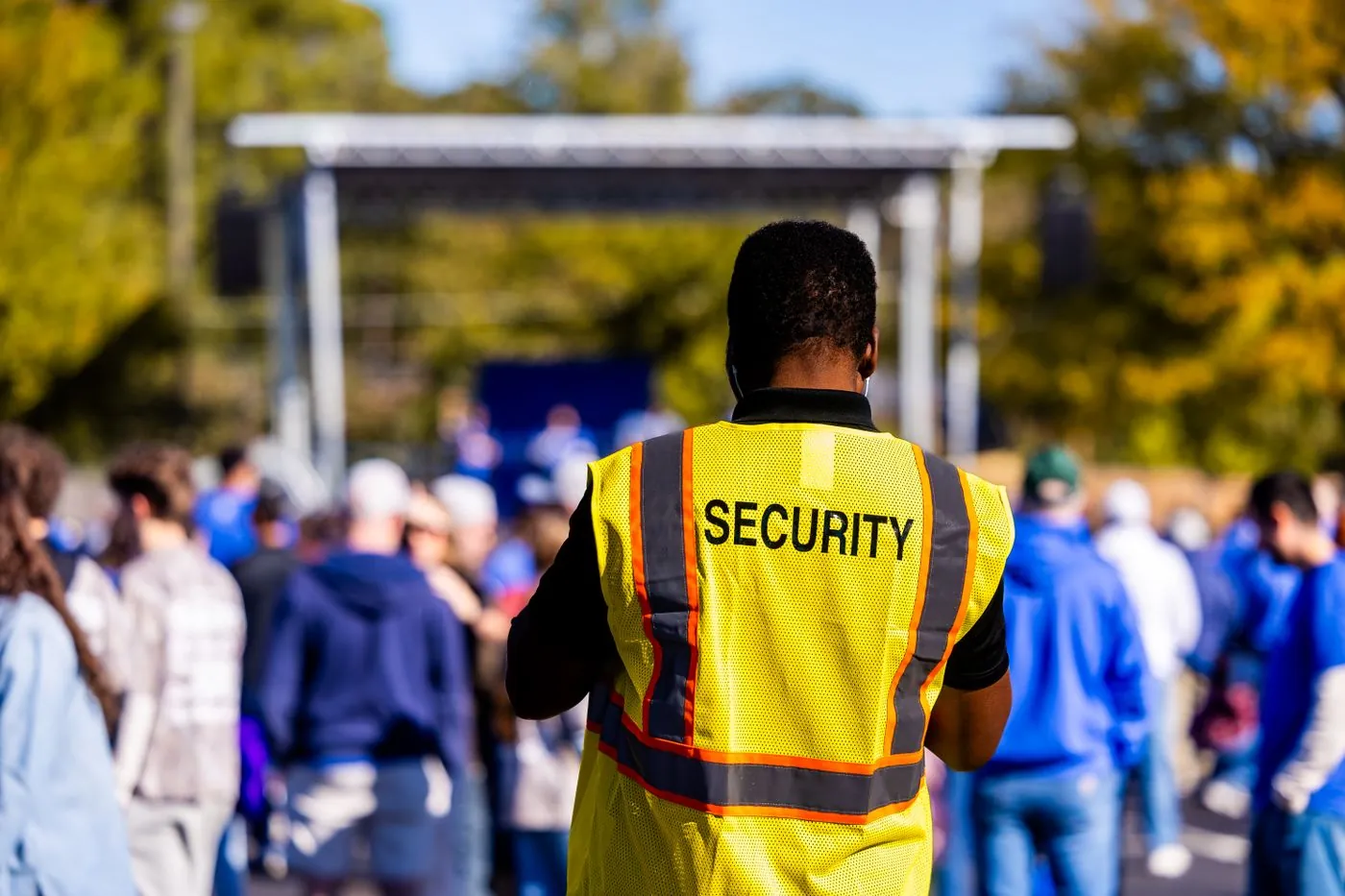 Stadium security staff using radios to manage crowd flow at a sporting event